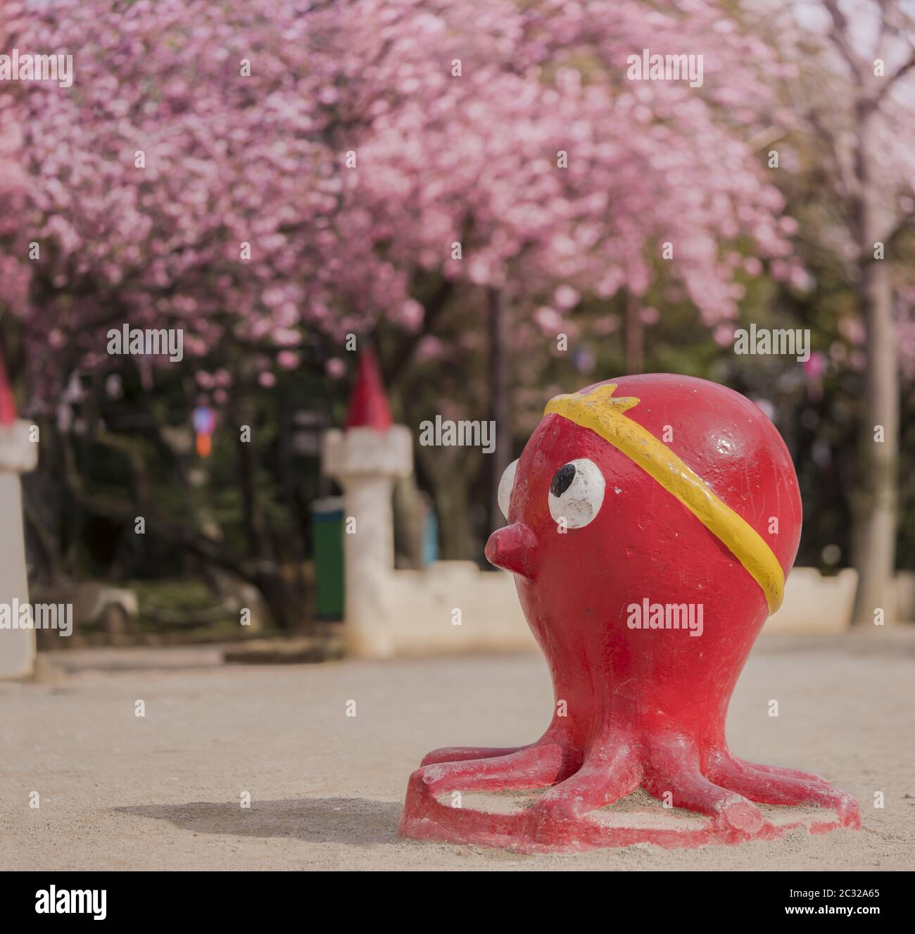 Funny red octopus sculpture looking at the cherry blossoms of Asukayama Park in the Kita district Stock Photo
