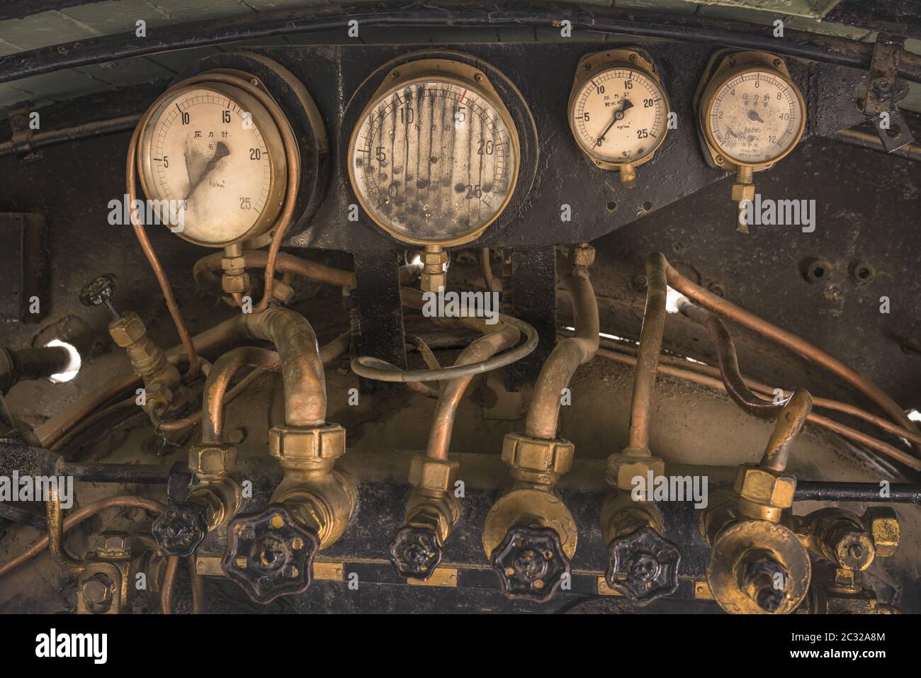 Golden and black Pressure gauge and Feed water pump valves of an old steam engine in Asukayama Park Stock Photo