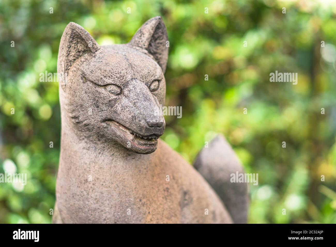 Statue of foxes inari, deity of rice in the Shinto shrine of Mejiro Toyosaka Inari Jinja in Tokyo. Stock Photo