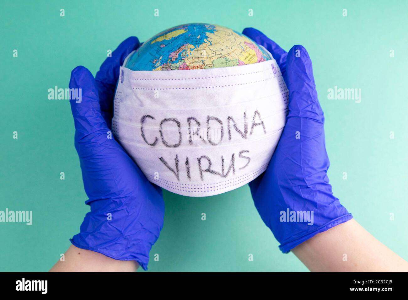 World Corona virus attack concept. world earth put mask to fight against Corona virus. Concept of fight against virus, danger and public health risk d Stock Photo