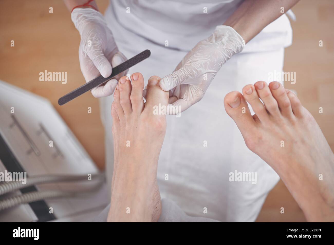 Pedicurist doing professional medical pedicure procedure in beauty