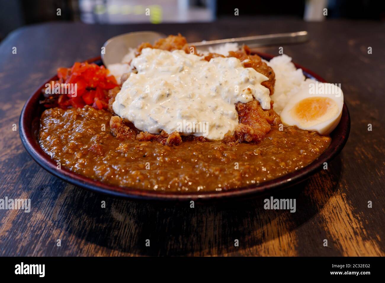 Close up view at Japanese Fried Chicken Nanban style curry with rice, boiled egg and red pickled