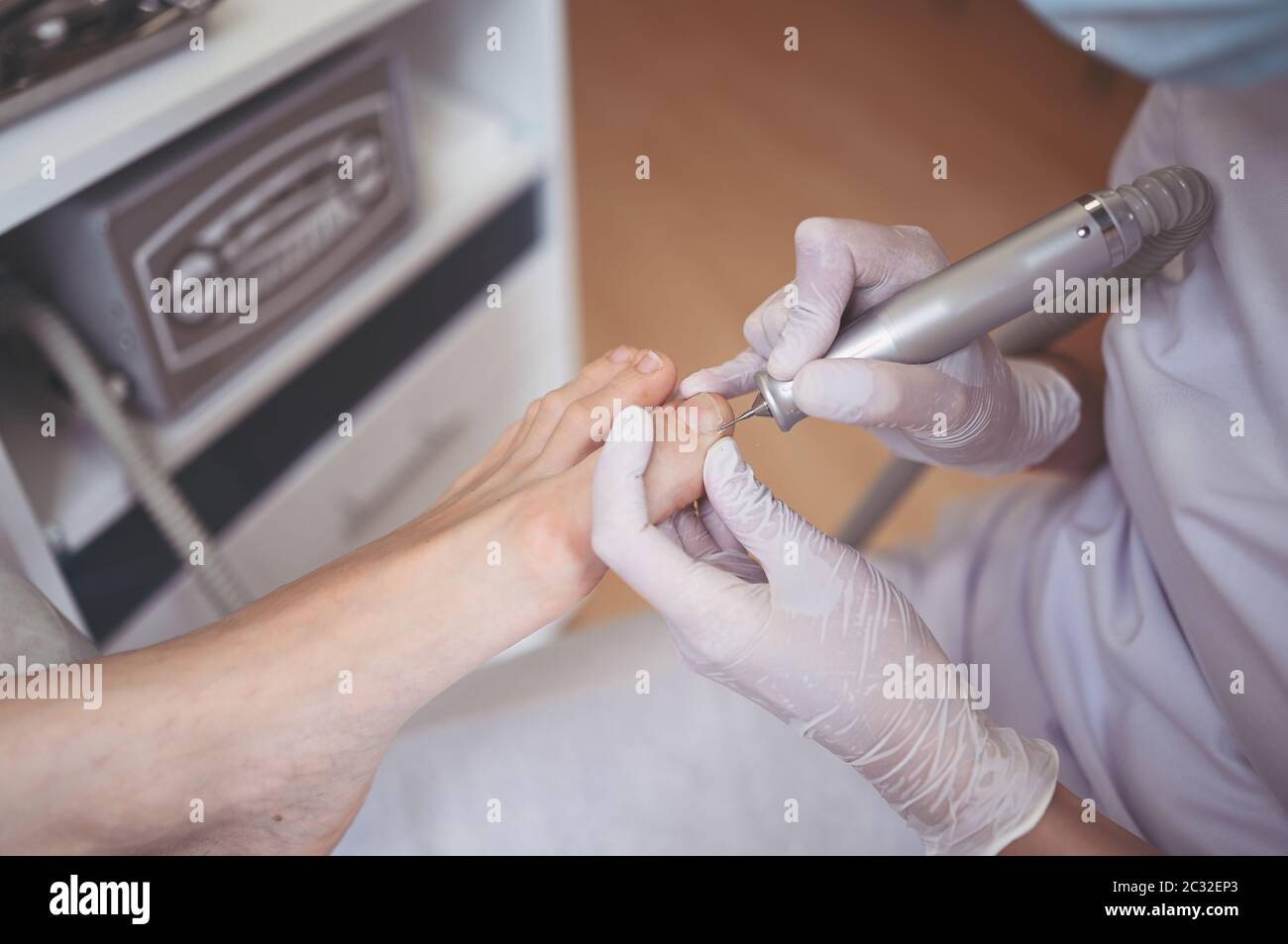 Hardware medical pedicure with nail file drill apparatus. Patient on