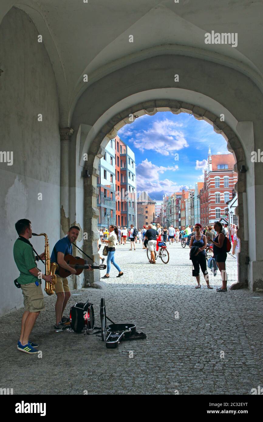 Musicians earn their living by playing guitar and saxophone in Gdansk Stock Photo