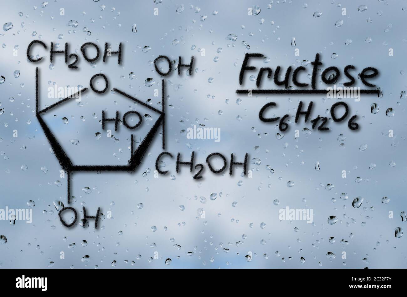 Fructose Model Building Structural model of Fructose drawn on the glass with raindrops Stock ...