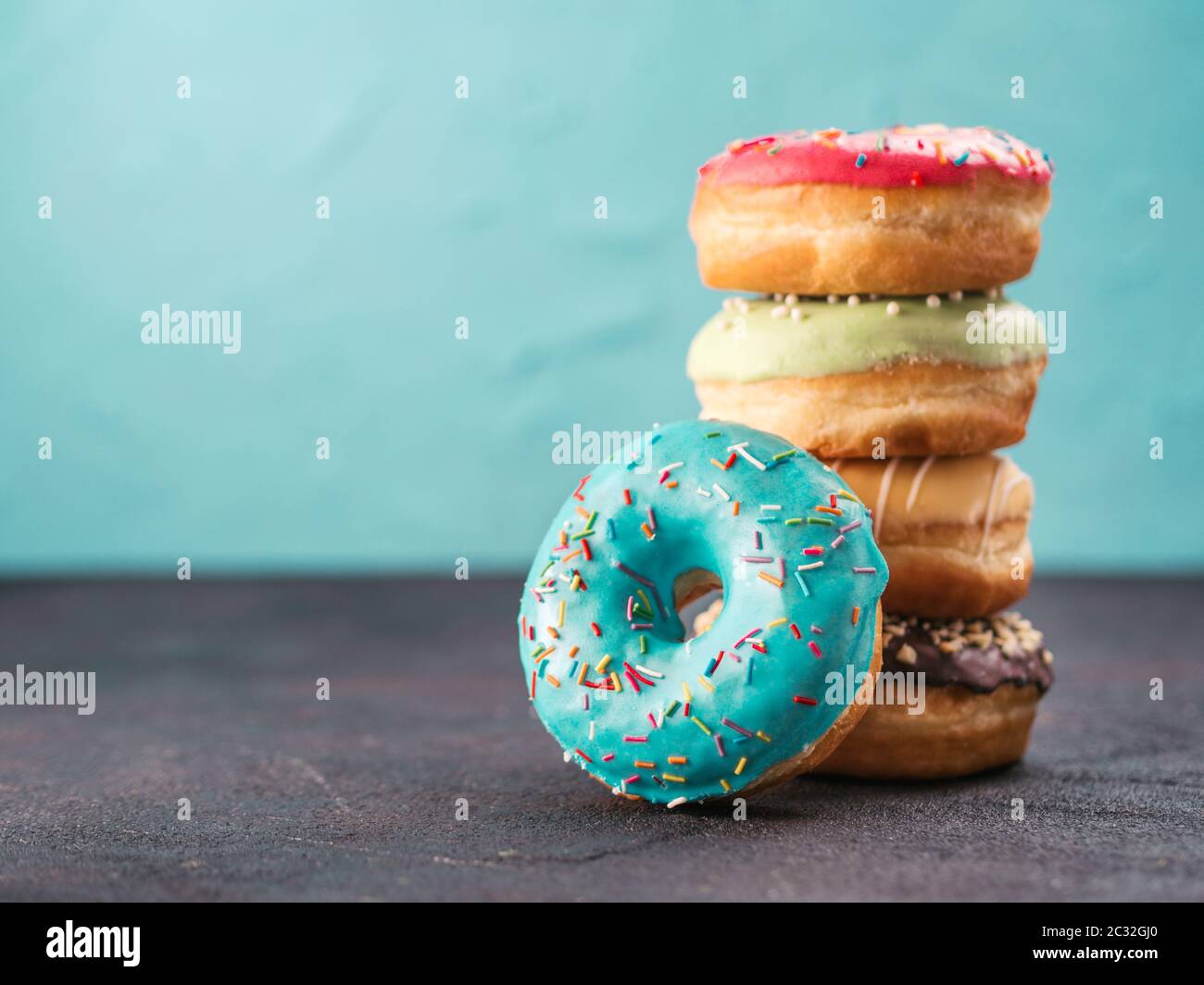 Stack of assorted donuts, copy space Stock Photo