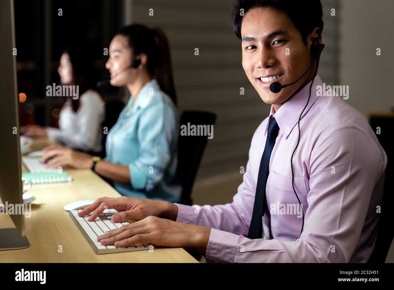Call Center working hard at night. Stock Photo