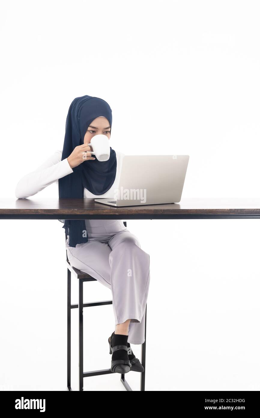 Muslim girl using laptop coffee Stock Photo