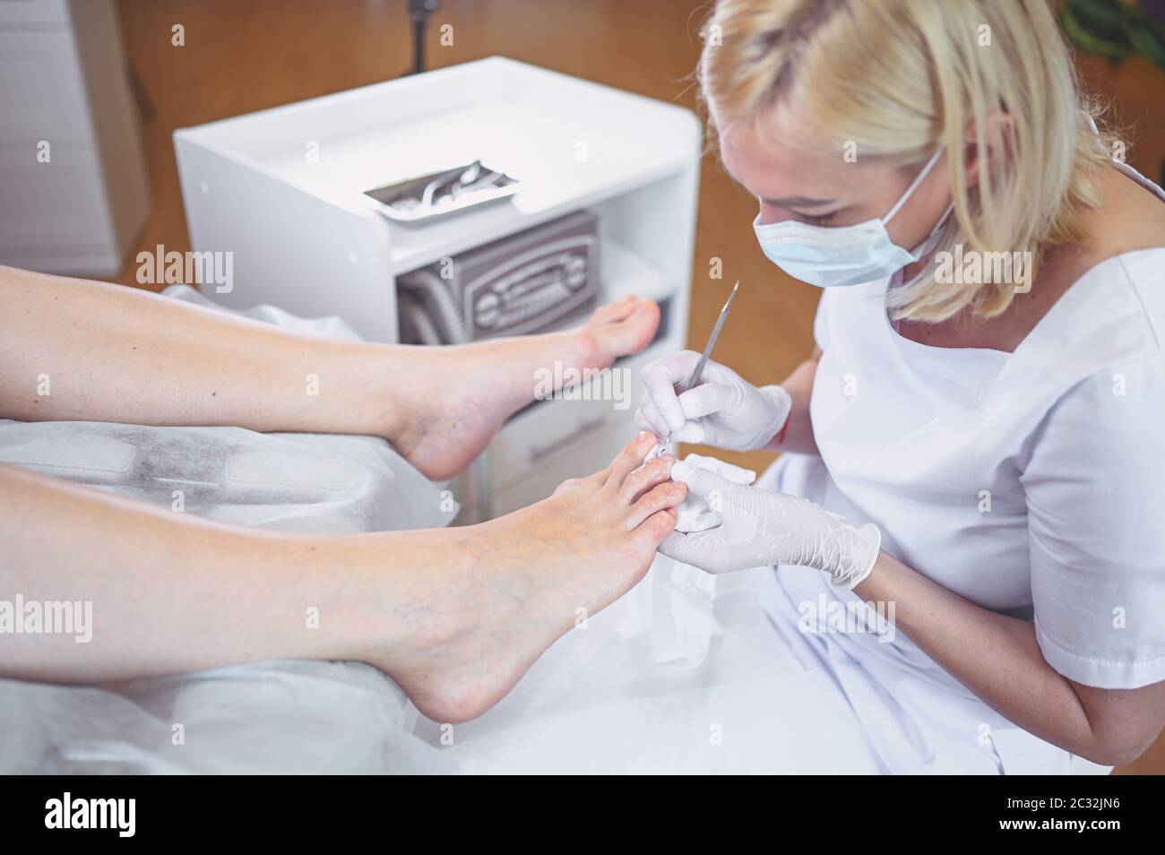 Professional medical pedicure procedure close up using double nail ...