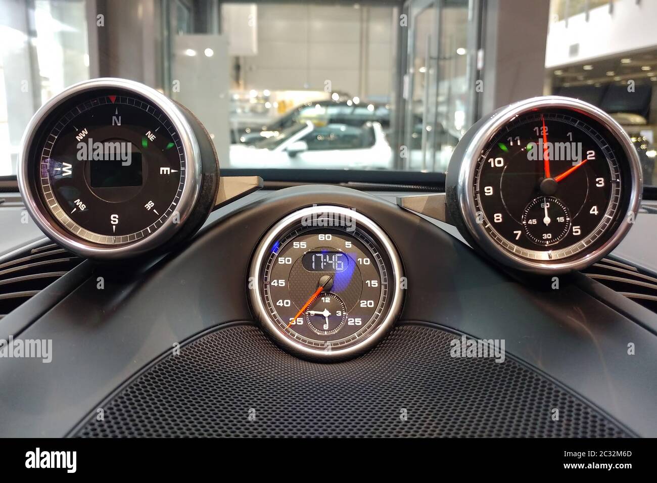 Interior details of a sports car. Sports chronometer with electronic clock, compass or analog