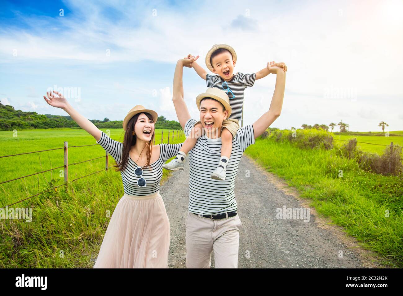 happy family having fun and walking on the country road Stock Photo