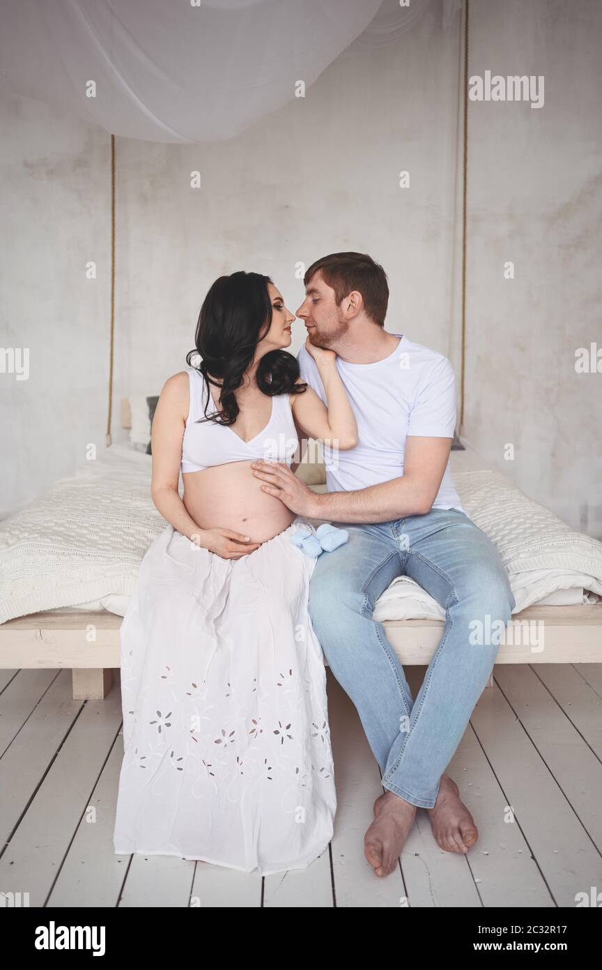 Pregnancy concept - happy man hugging his beautiful pregnant wife at ...