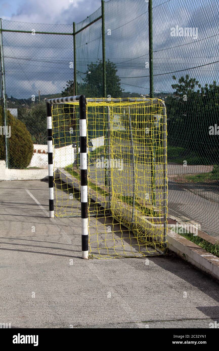 black and white soccer goal net on a concrete soccer surface camp Stock