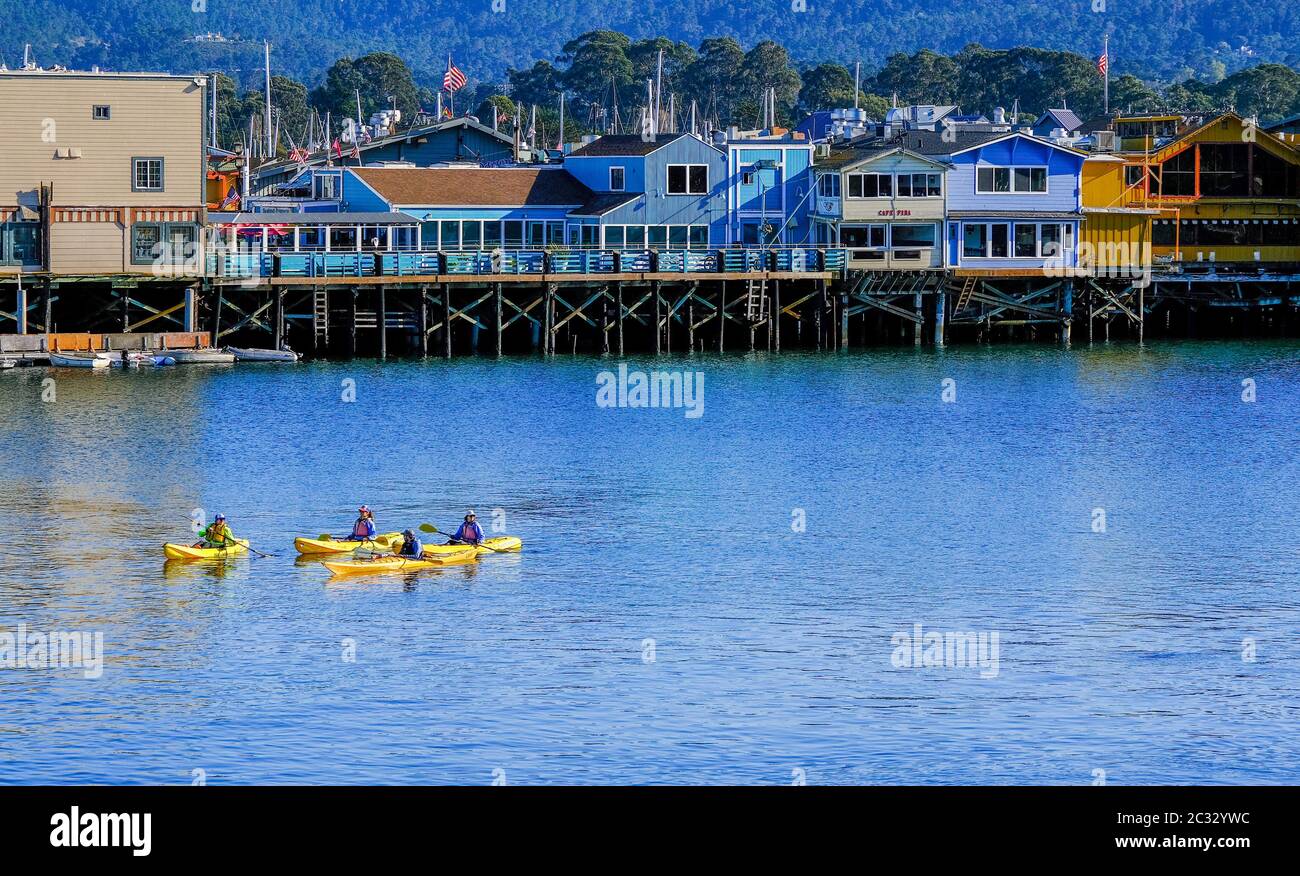 Four Yellow Kayaks in Monterey Stock Photo