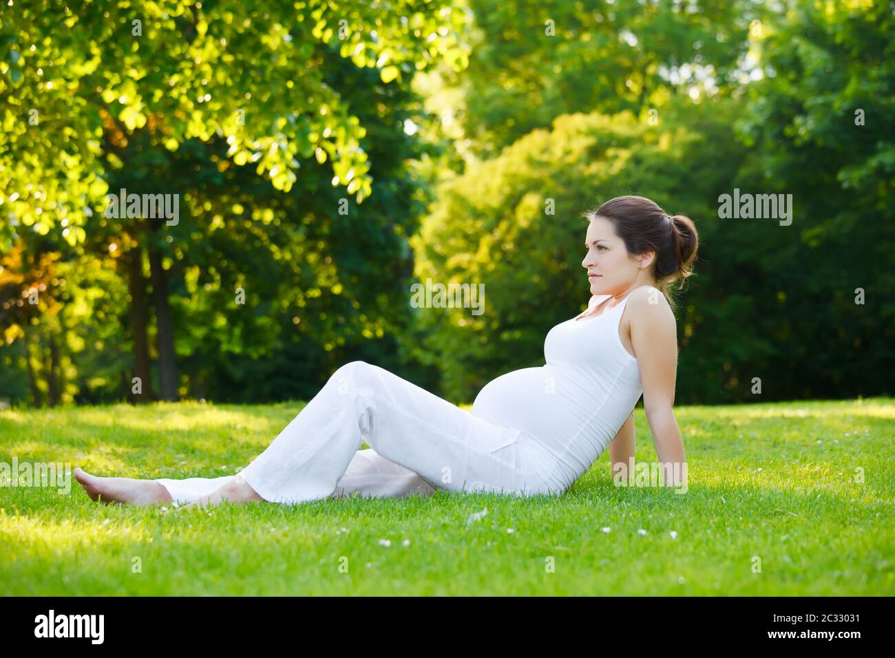 Beautiful pregnant woman in the park Stock Photo - Alamy