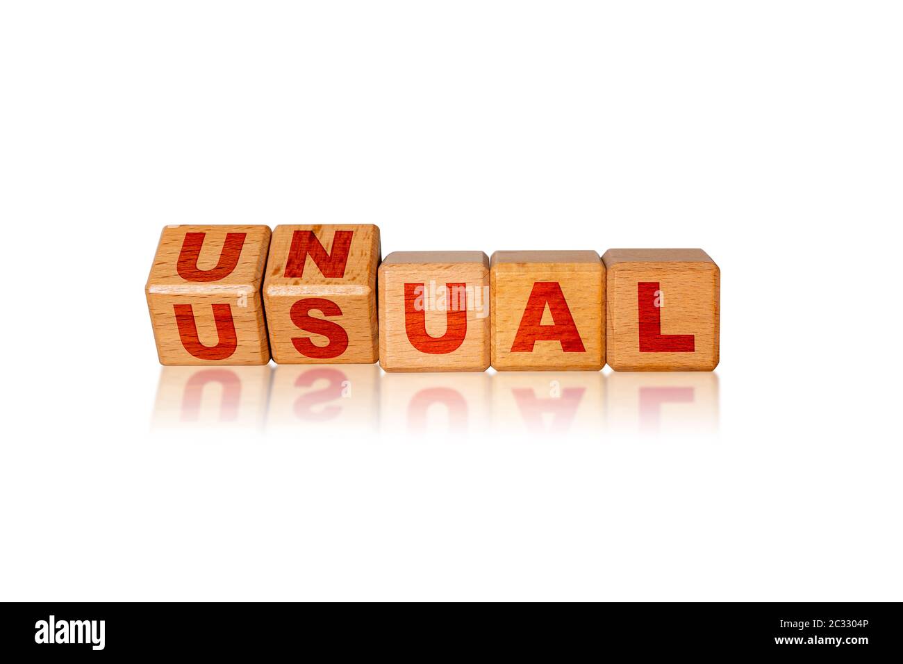 Concept of the word Unusual displayed in unconventional way by use of alphabet blocks. Business as Unusual after Covid-19 coronavirus pandemic because Stock Photo