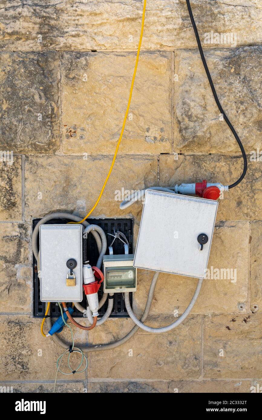 Electric Power Box With Cables and Wires at Exterior Wall Stock Photo
