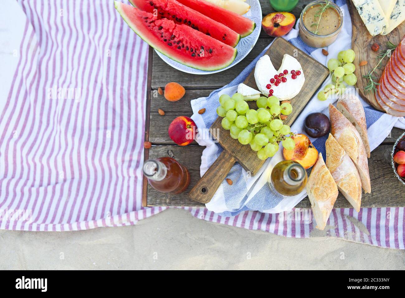 Picnic on the beach at sunset in the style of boho Stock Photo