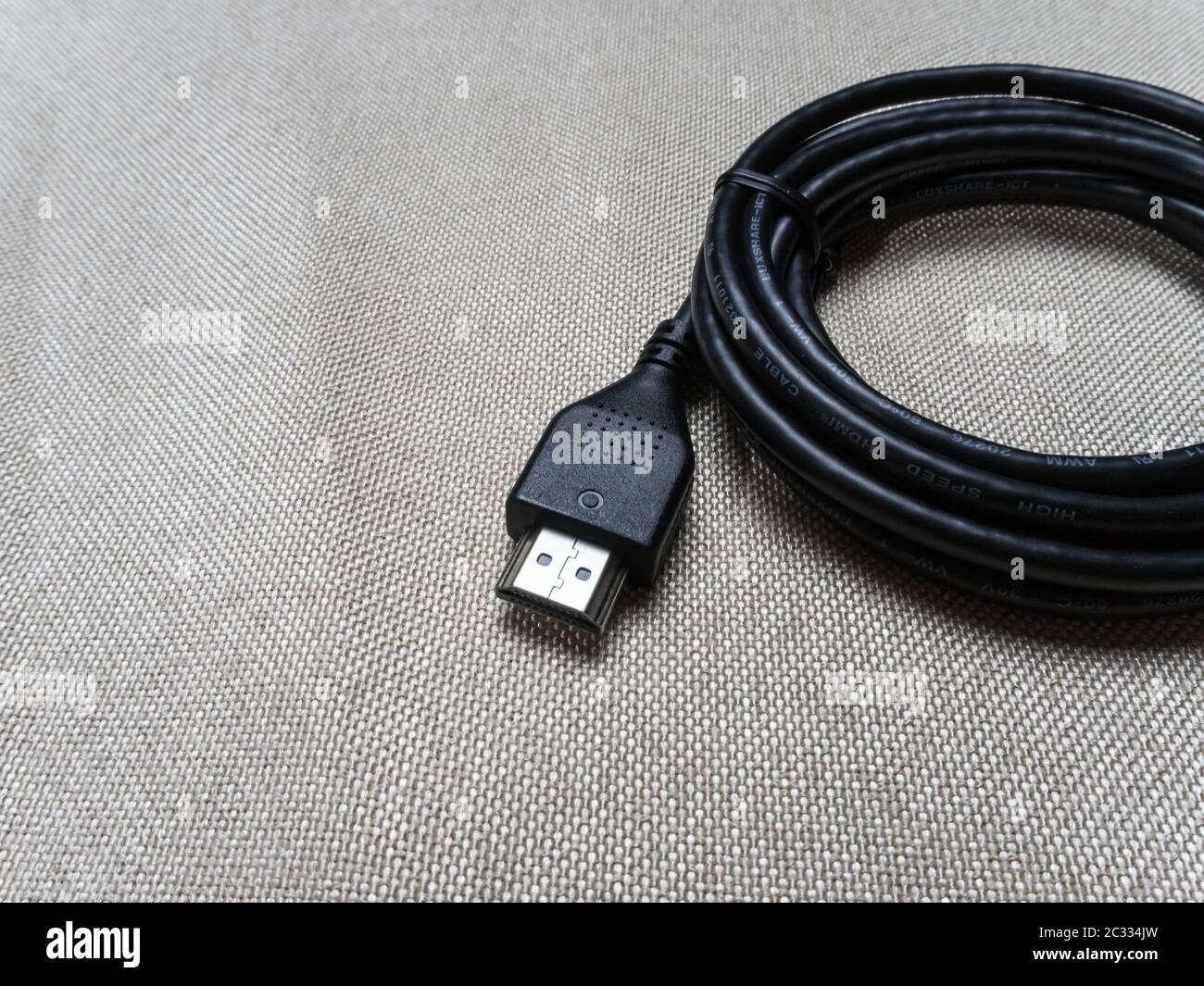 Black twisted hdmi cable for Sony PlayStation console on the table 07 04 2019 Stock Photo
