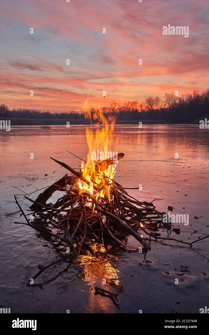 Fire burning on ice of a frozen lake Stock Photo Alamy