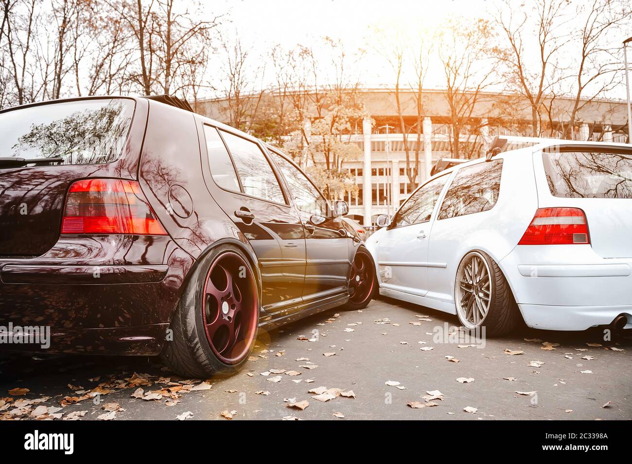 Two modified low cars in brown and light blue color. Stance custom cars  with a forged