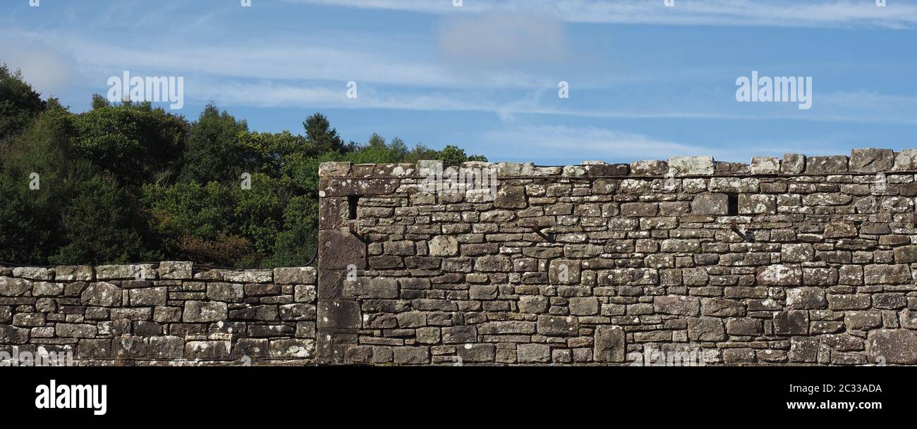 wide grey stone wall useful as a background Stock Photo - Alamy