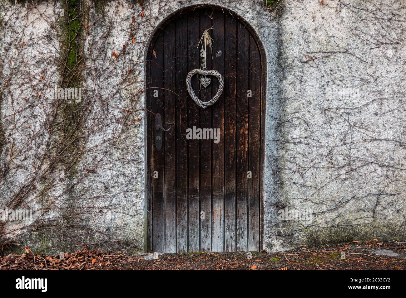 Old wooden door in a long stone wall Stock Photo - Alamy