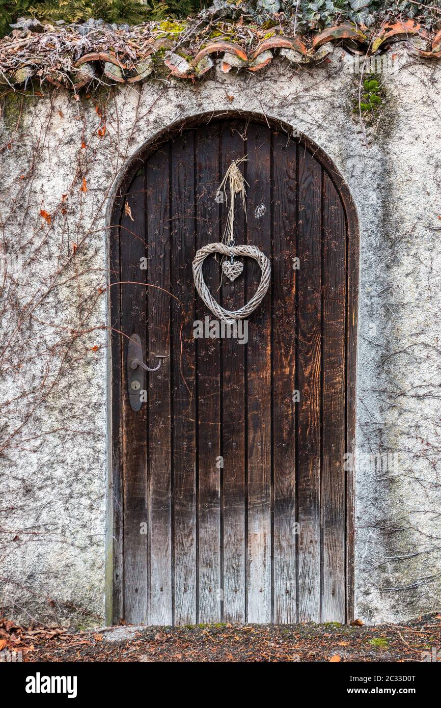 Old wooden door in a long stone wall Stock Photo - Alamy