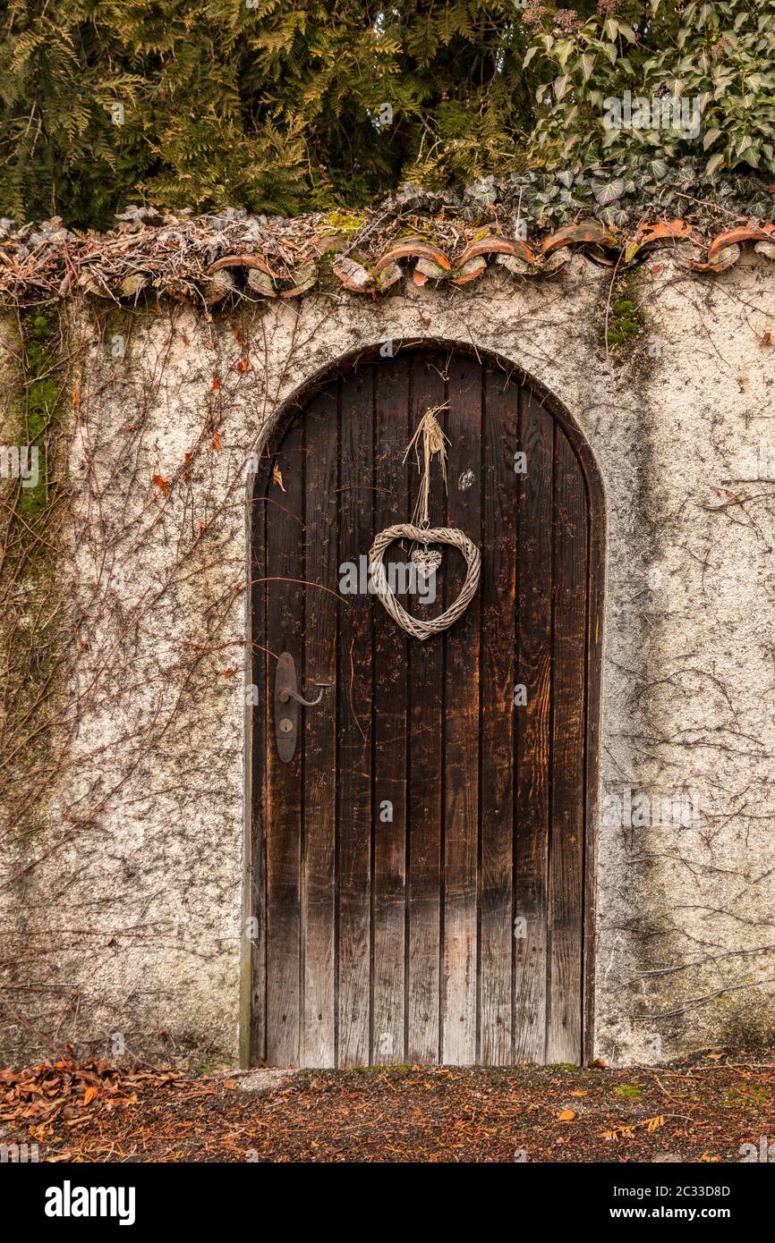 Old wooden door in a long stone wall Stock Photo - Alamy