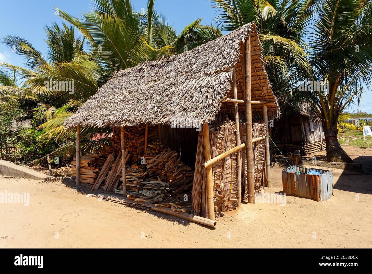 sale of firewood on street marketplace in Maroantsetra city, Madagascar. Deforestation is big problem. Stock Photo