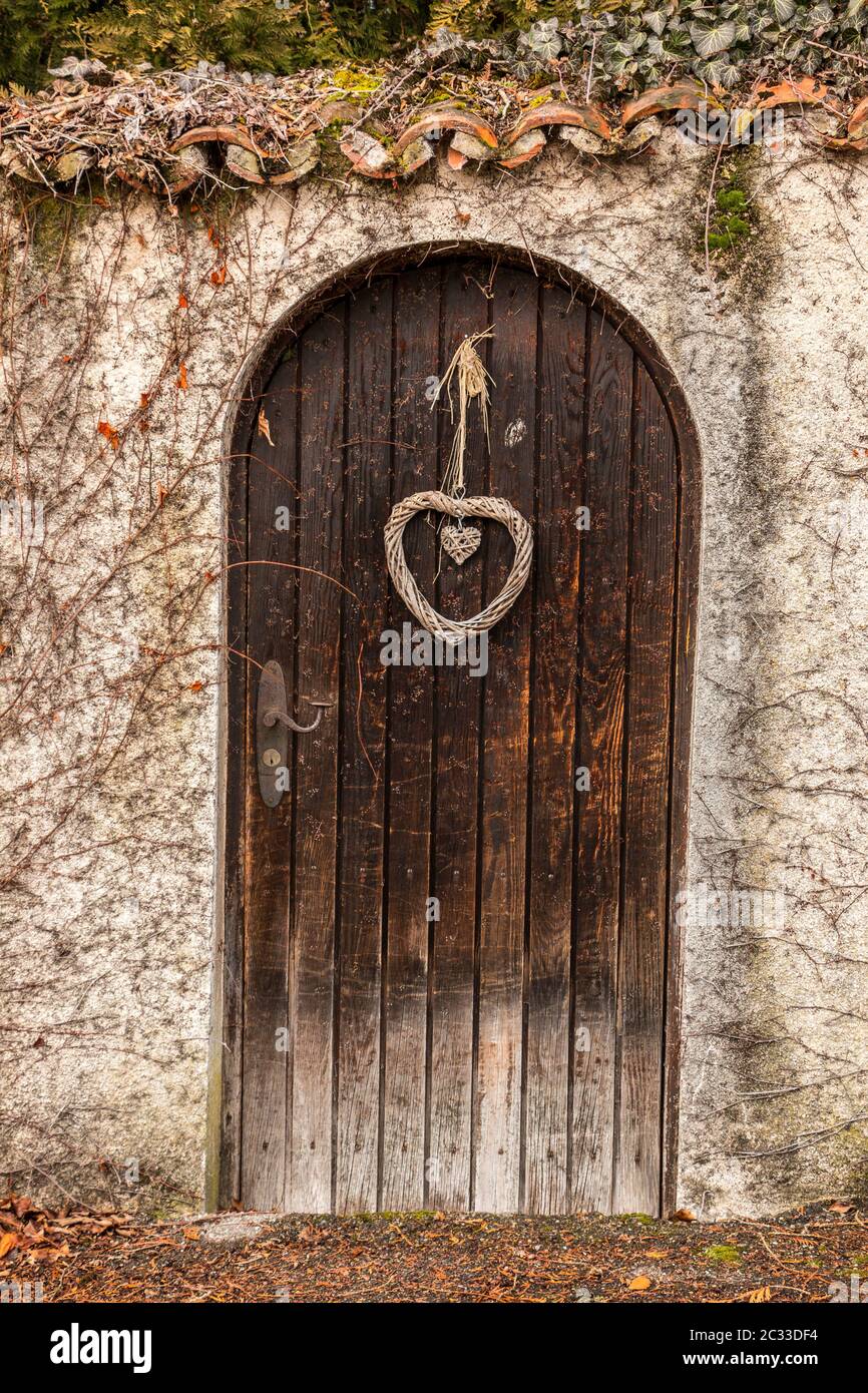 Old wooden door in a long stone wall Stock Photo - Alamy