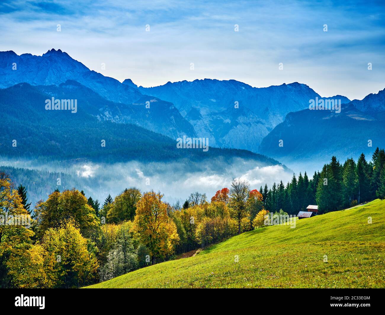 View from the top of mountain Eckbauer in Bavaria to alps in the region of Garmisch-Partenkirchen, Germany in autumn on a sunny day in autumn Stock Photo