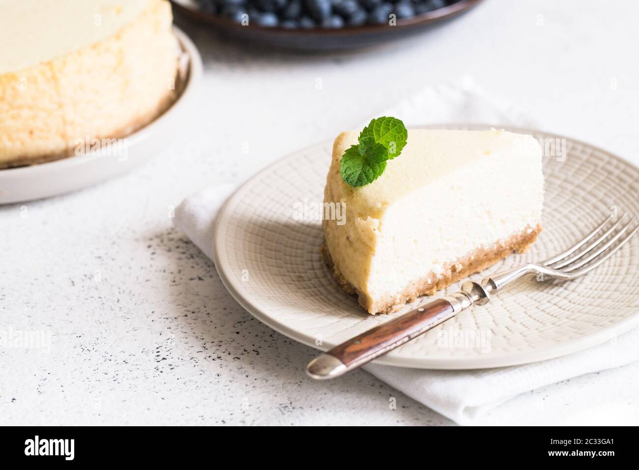 Slice Of Classical New York Cheesecake On White Plate. Closeup View. Home bakery concept/ Stock Photo
