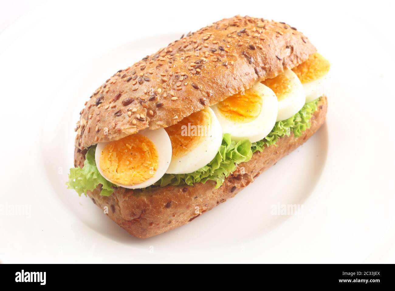 Multigrain Bread With Lettuce And Boiled Egg On A White Plate Stock Photo