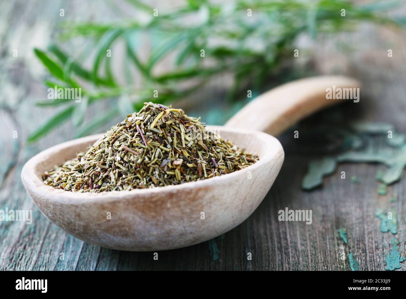 Dried Rosemary On A Wooden Spoon Stock Photo
