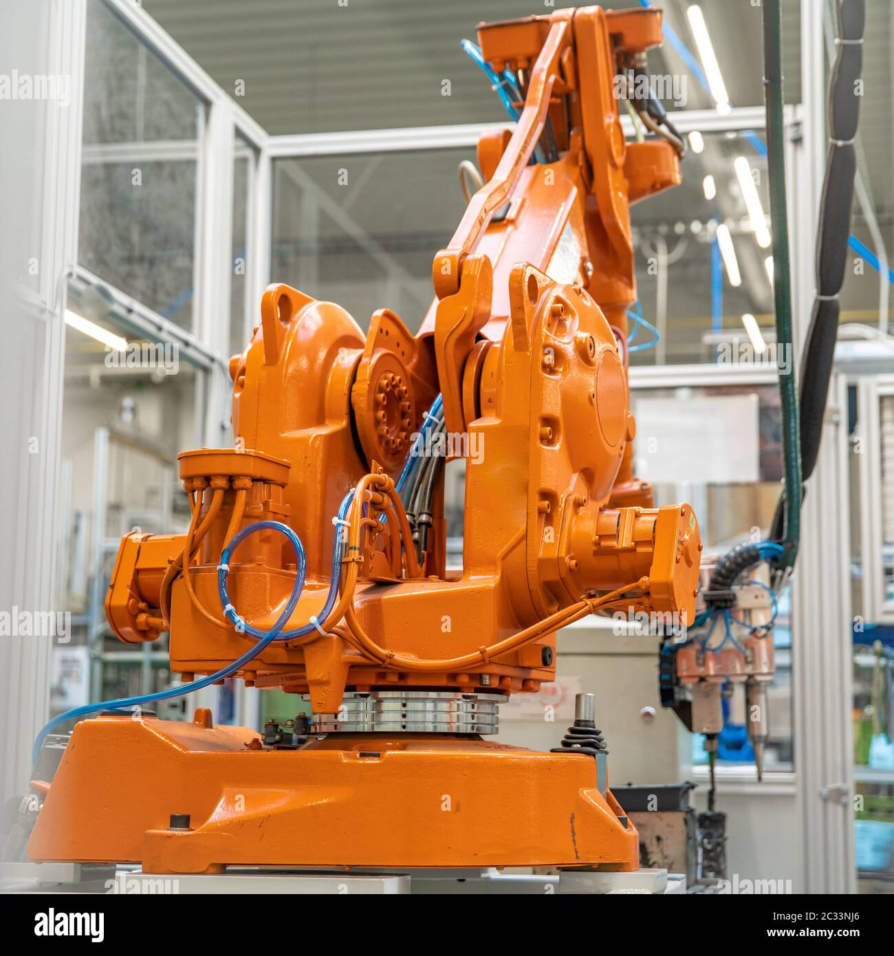 robot arms in the factory performs precise work according to the specified program. Stock Photo