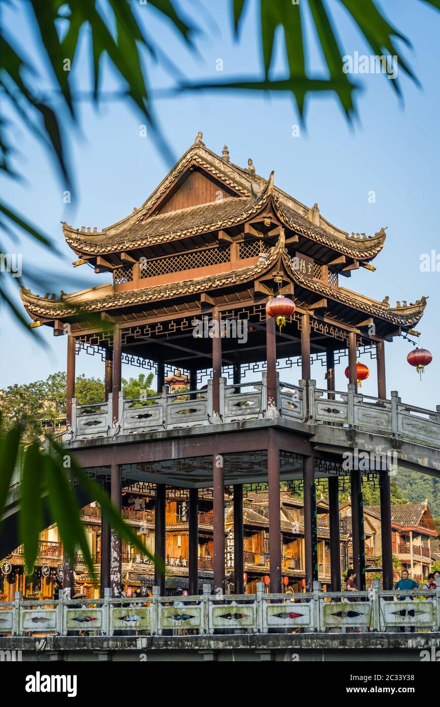 Roof over stone bridge over Tuo Jiang river in Feng Huang Stock Photo