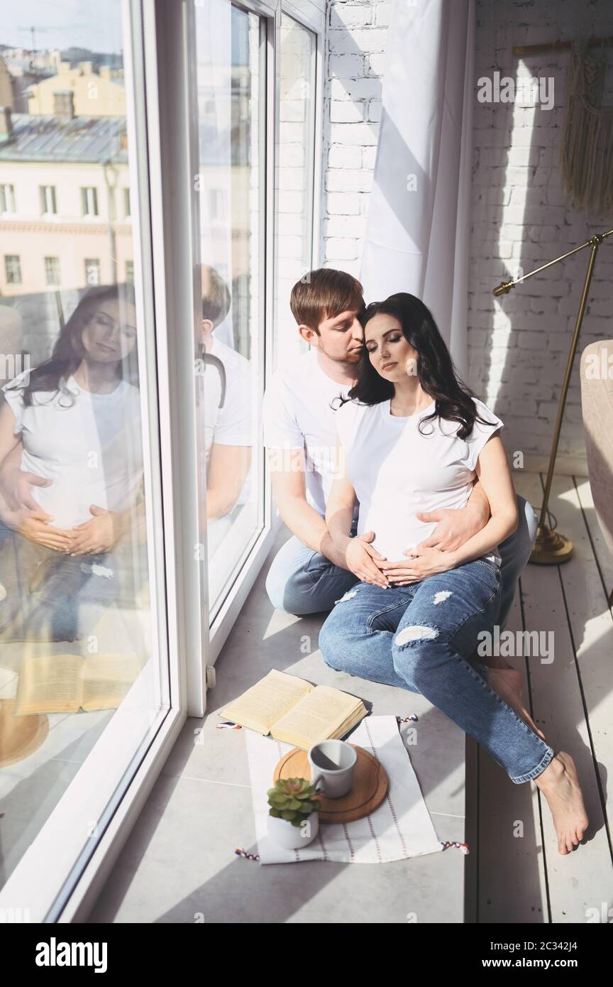 Pregnancy concept - happy man hugging his beautiful pregnant wife at ...