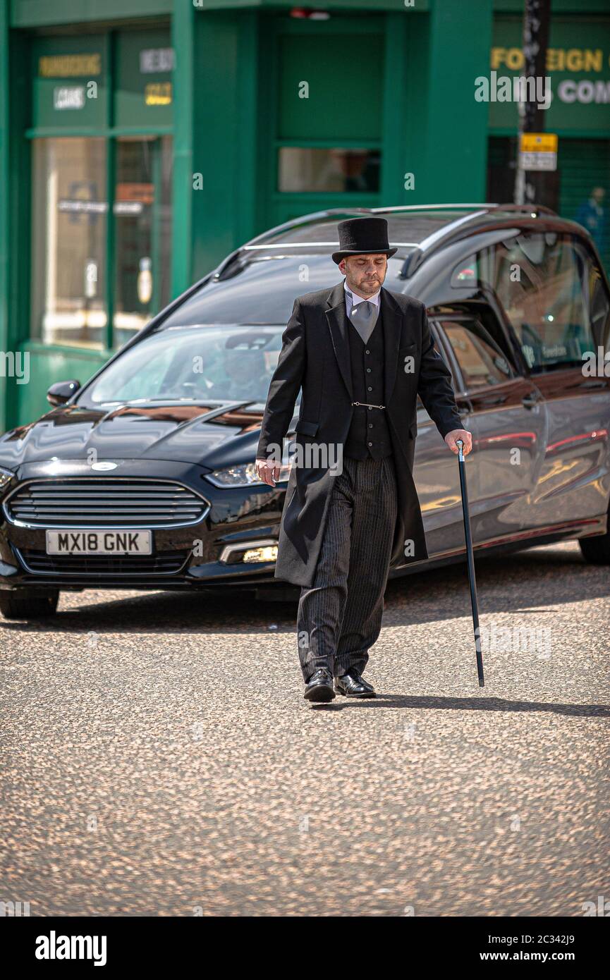 Alloa, UK. 18th June, 2020. The funeral director walks in front of the