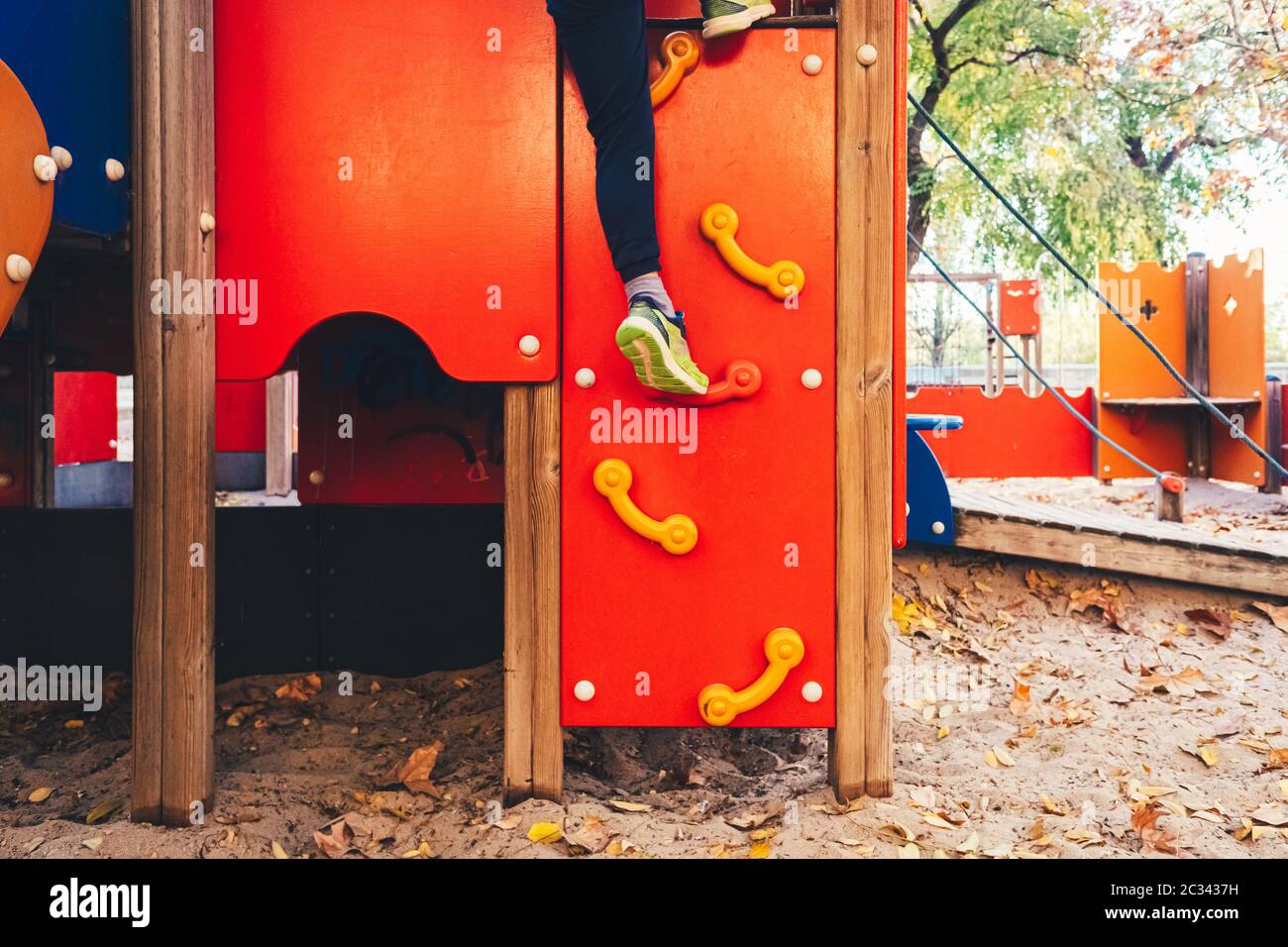 Feet hanging as a child playing in a playground. Stock Photo