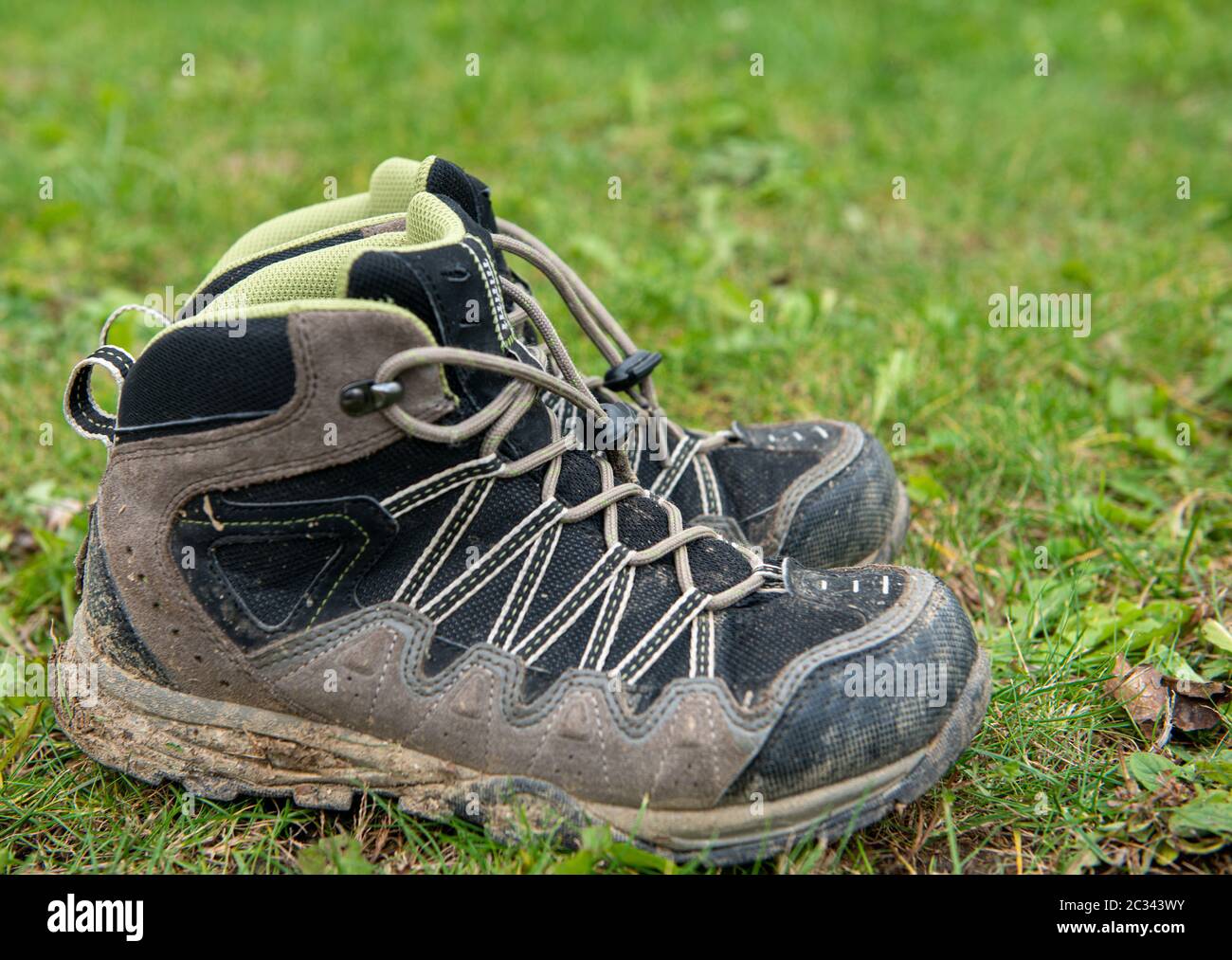 Pair of traveler hiker shoes standing in the grass Stock Photo