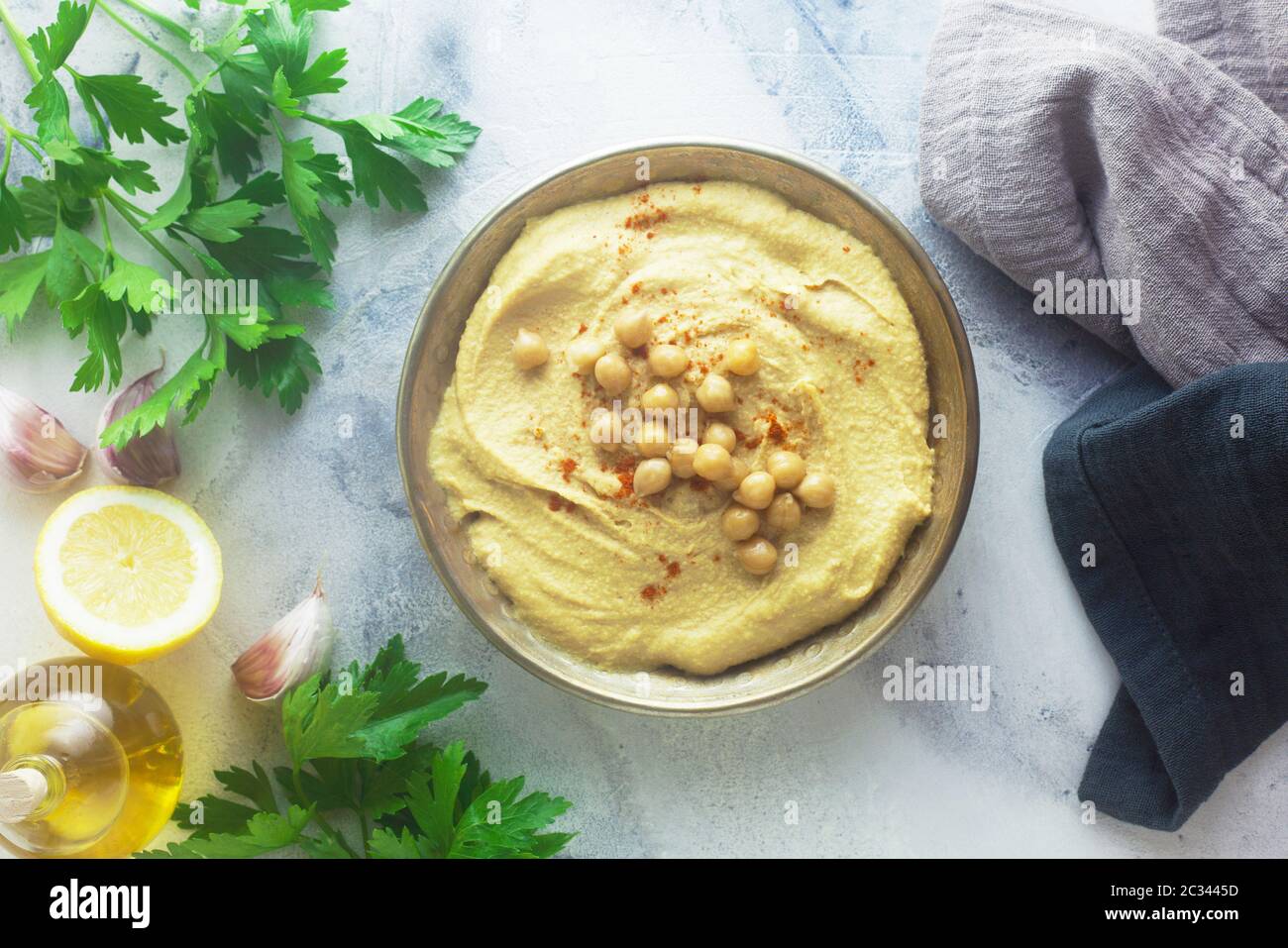 Hummus With Ingredients On A Stone Background Stock Photo