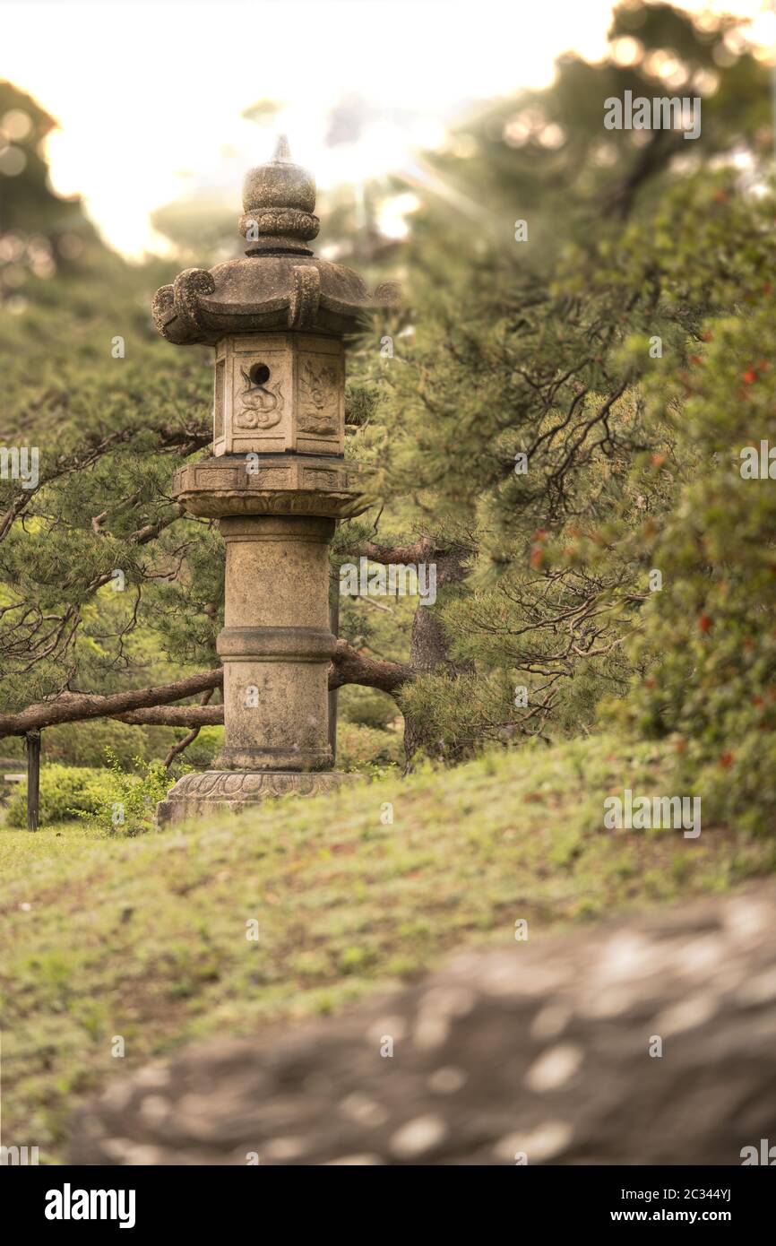 Stone lantern in sunset light of the Rikugien Park of Bunkyo district, north of Tokyo. Stock Photo