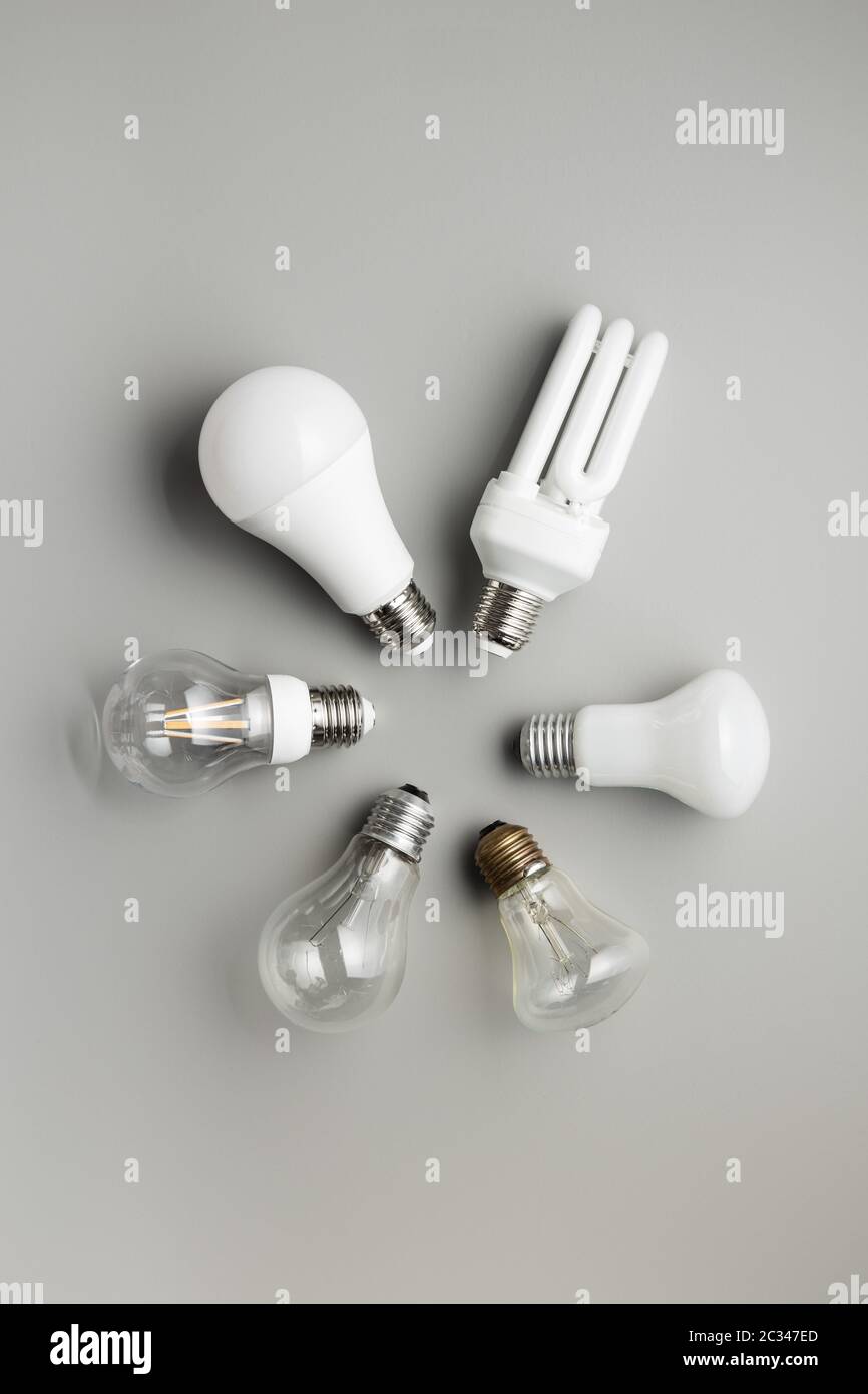 Energy saving and classic light bulbs on gray background. Top view. Stock Photo