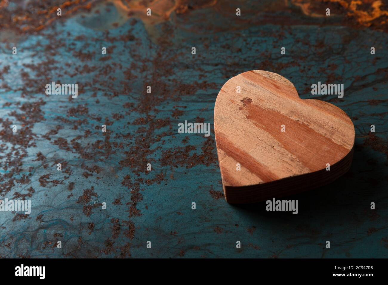 Wooden heart on a metal background with copy space Stock Photo - Alamy