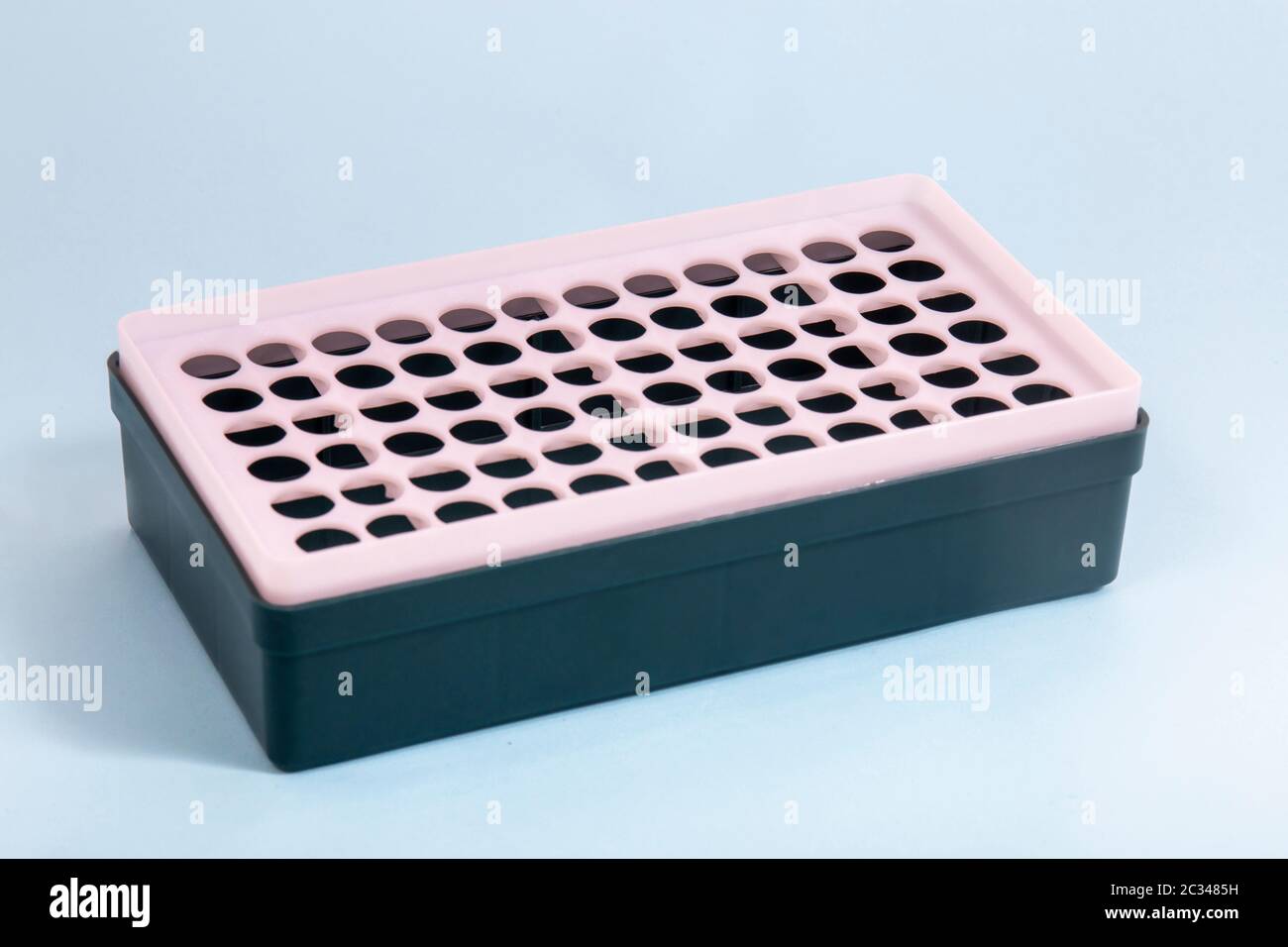 Plastic laboratory vial rack isolated on blue background Stock Photo ...