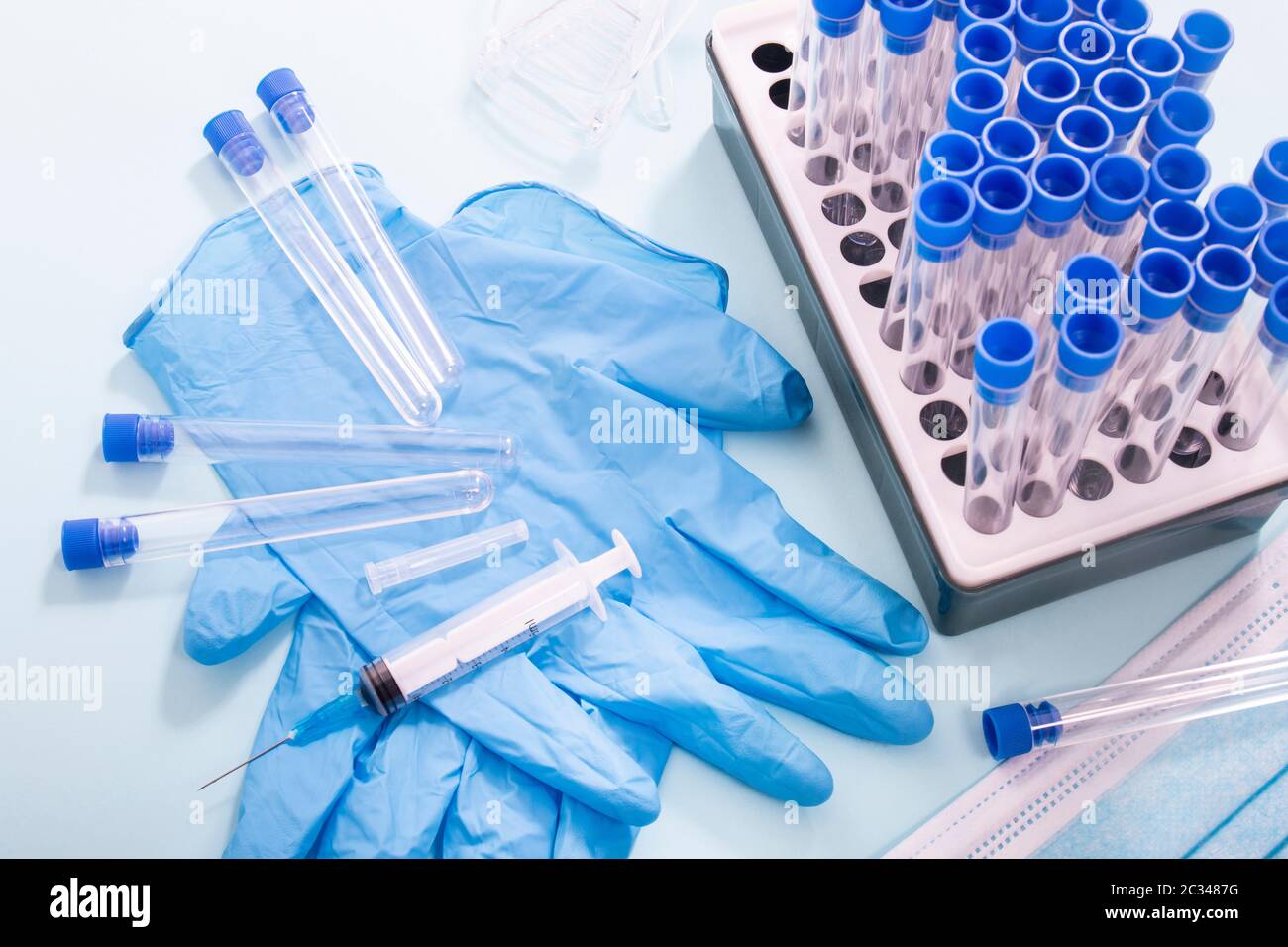 Several laboratory objects including protective mask, vial rack ...