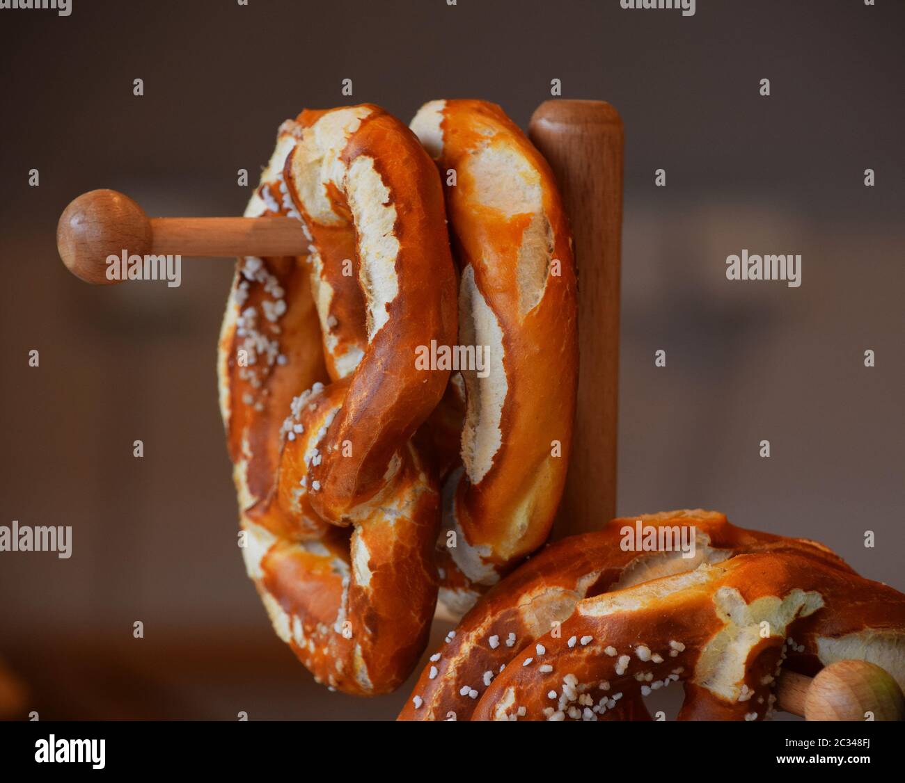 Close up several fresh traditional German pretzel bread knots hanging