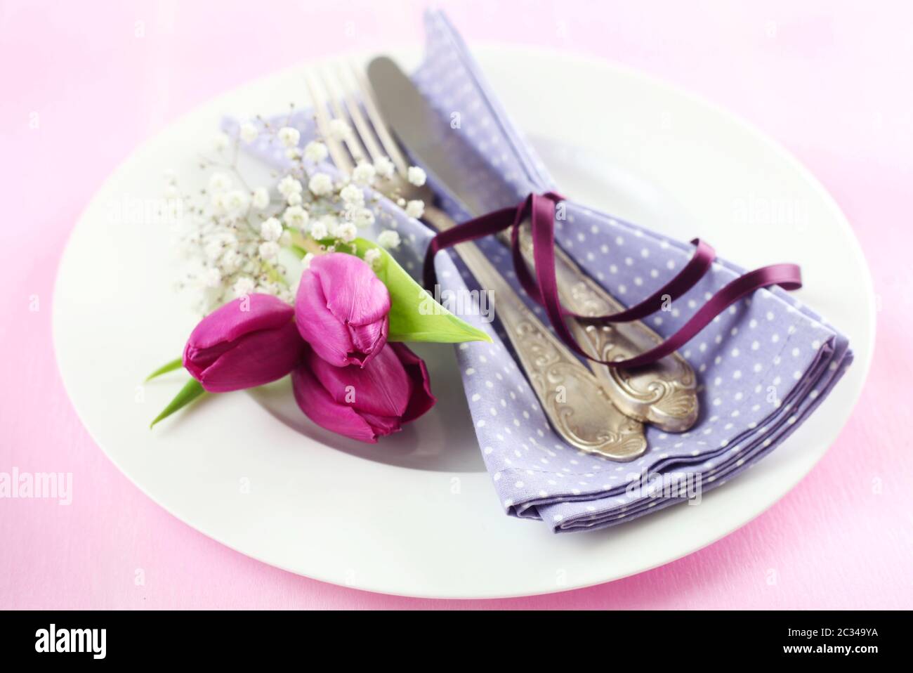 Place Setting With Tulips On A Pink Background Stock Photo