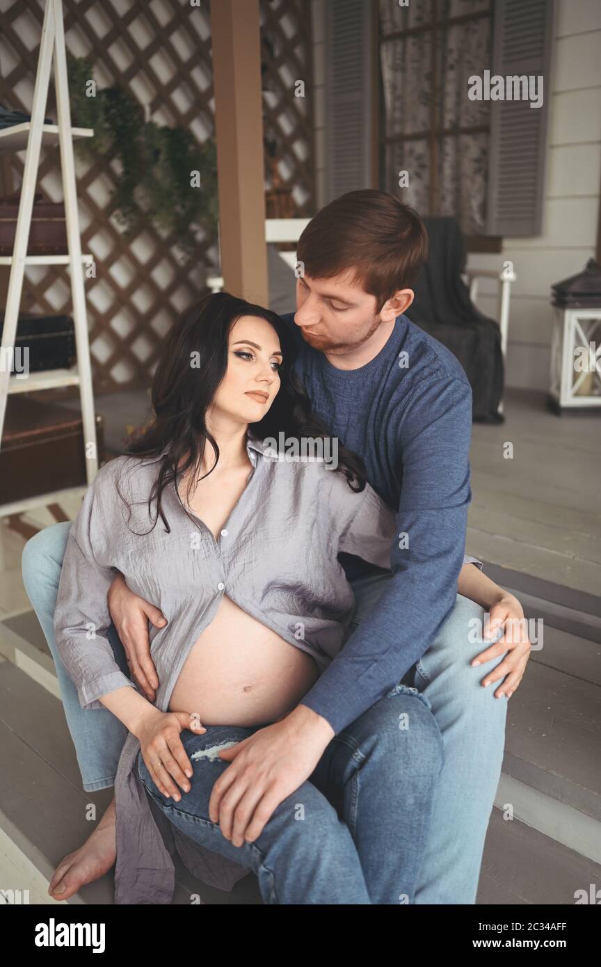 Pregnancy concept - happy man hugging his beautiful pregnant wife at ...